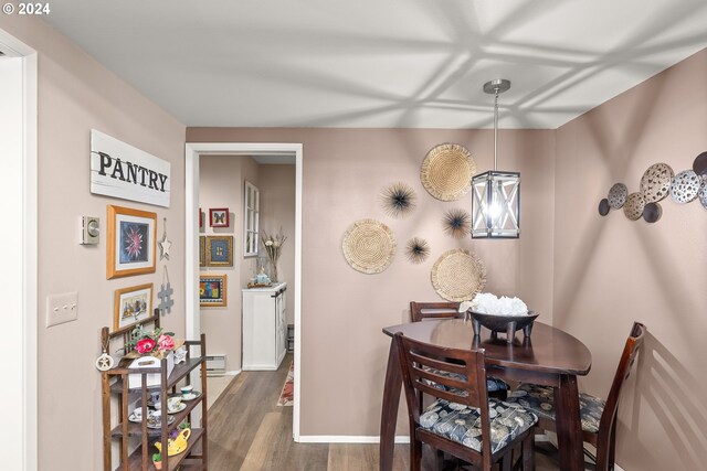 dining space featuring baseboard heating and dark hardwood / wood-style floors