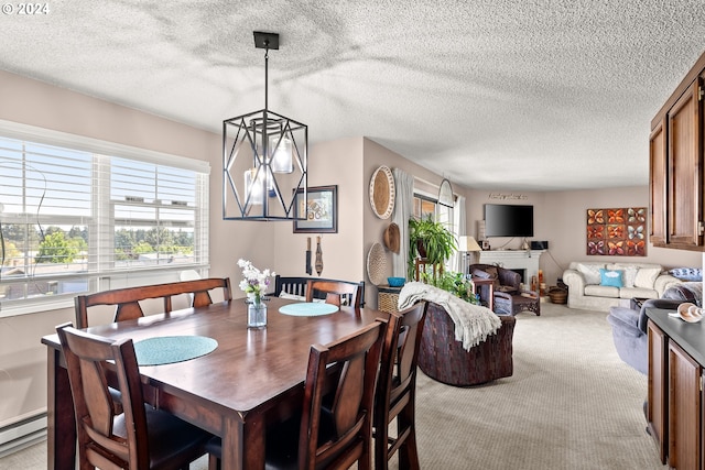 dining space with a chandelier, a textured ceiling, baseboard heating, and light colored carpet