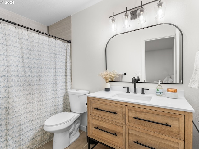 bathroom featuring toilet, a textured ceiling, vanity, and tile patterned floors