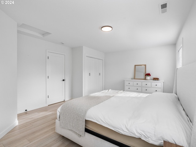 bedroom featuring a closet and light wood-type flooring