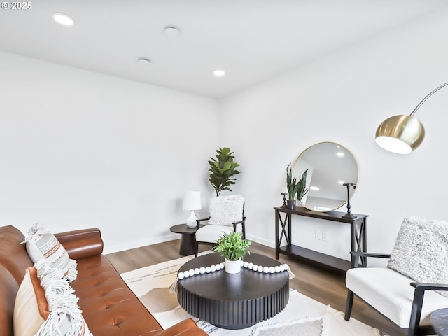 living area with recessed lighting, baseboards, and wood finished floors