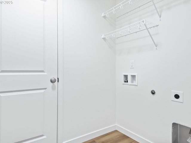 laundry area featuring hookup for a washing machine, hookup for an electric dryer, laundry area, wood finished floors, and baseboards