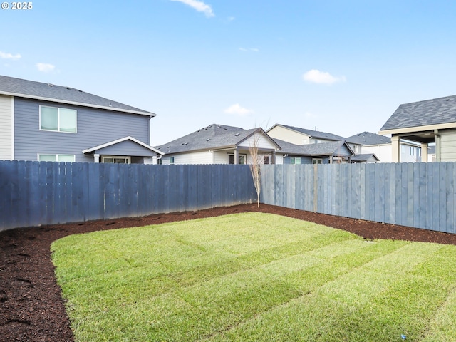 view of yard with a fenced backyard