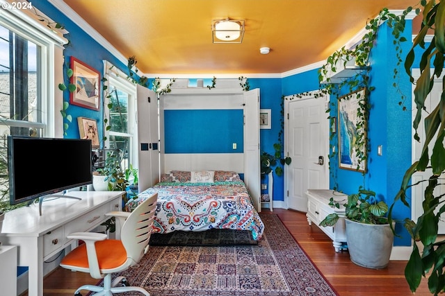 bedroom featuring crown molding and dark hardwood / wood-style floors