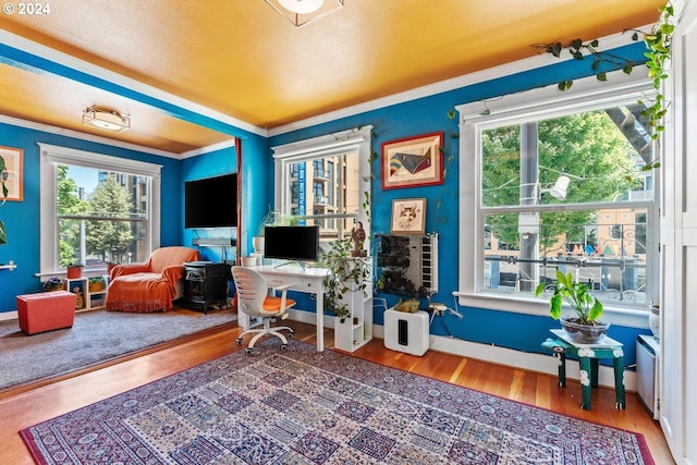 office space with wood-type flooring and crown molding