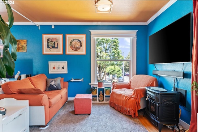 living area with ornamental molding, a wood stove, and light colored carpet