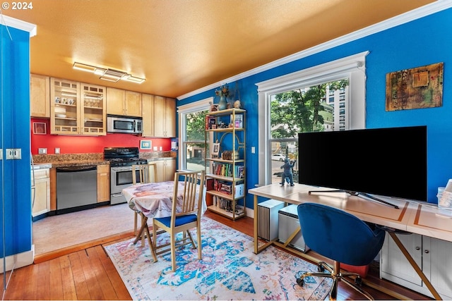 home office featuring light wood-type flooring and ornamental molding