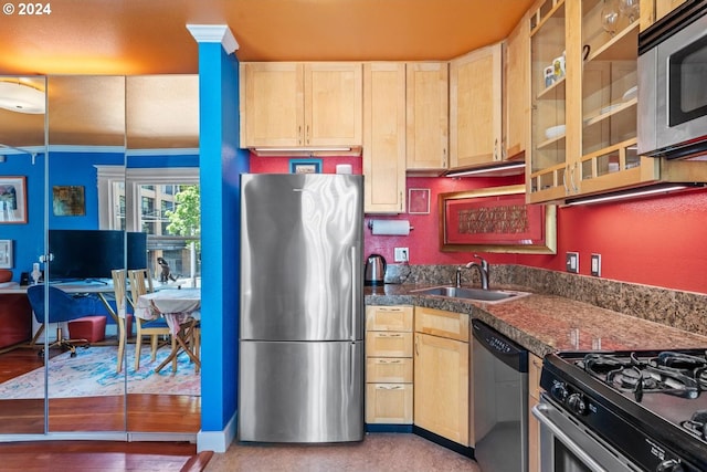 kitchen featuring stainless steel appliances, sink, light brown cabinetry, and ornamental molding