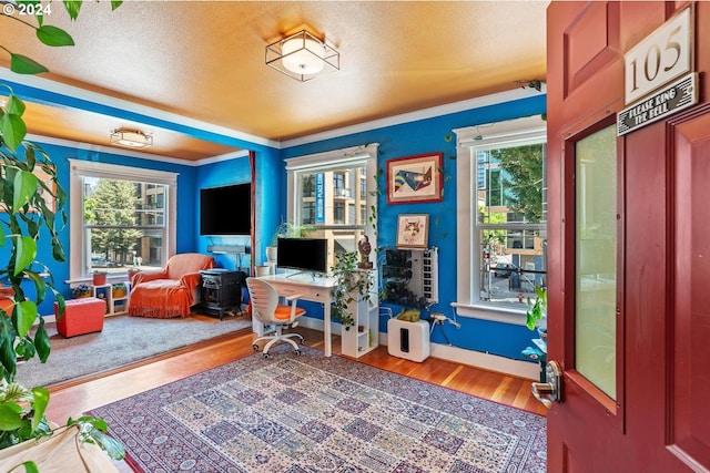 1104 SW Columbia St Unit 105, Portland, OR 97201 - rec room with plenty of natural light, wood finished floors, an office area, a textured ceiling, and crown molding