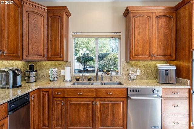 kitchen featuring sink, tasteful backsplash, dishwasher, and light stone counters