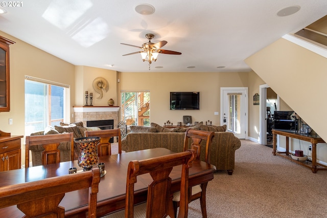 dining area featuring ceiling fan and light carpet