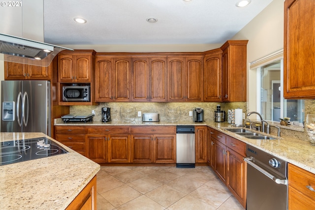 kitchen featuring light stone countertops, appliances with stainless steel finishes, backsplash, sink, and light tile floors