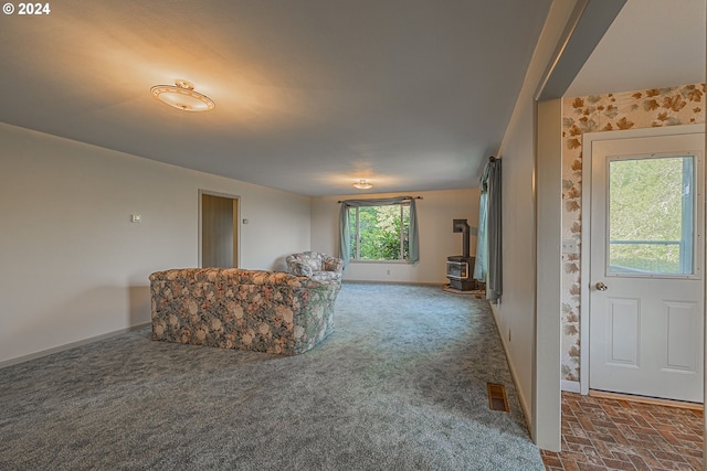 living room with carpet floors and a wood stove