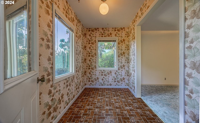 91235 N Bank Ln, Coquille, OR 97423 - empty room featuring wallpapered walls, brick floor, and baseboards