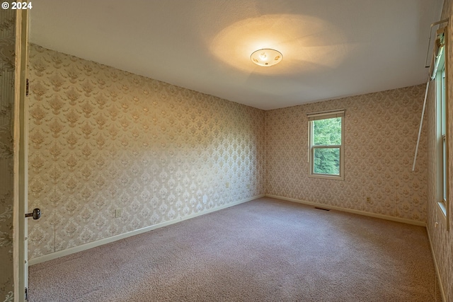 91235 N Bank Ln, Coquille, OR 97423 - spare room featuring wallpapered walls, carpet, and baseboards