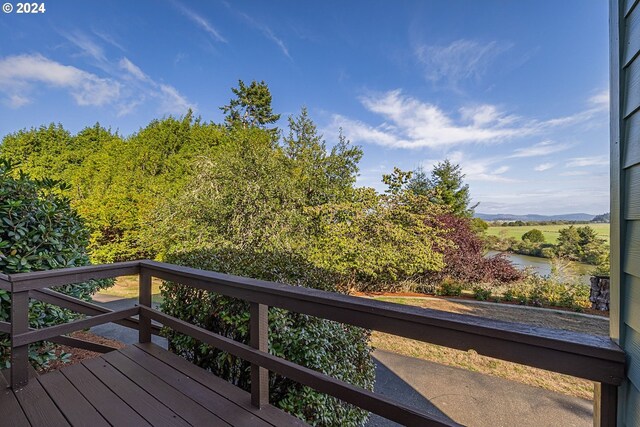 wooden deck featuring a water view