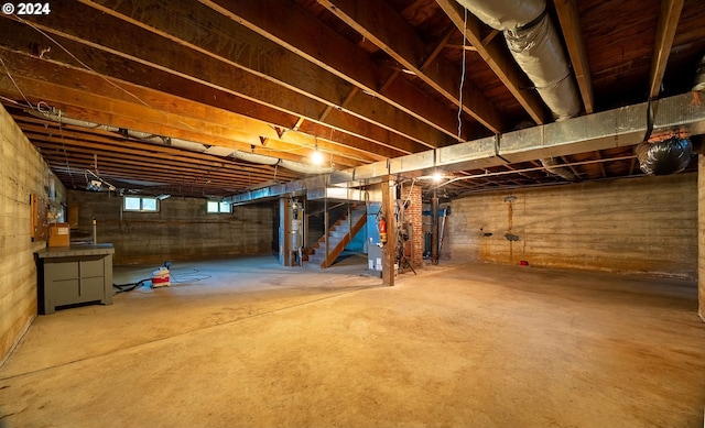 91235 N Bank Ln, Coquille, OR 97423 - basement featuring gas water heater, stairway, and heating unit