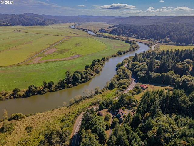 birds eye view of property featuring a water and mountain view and a rural view