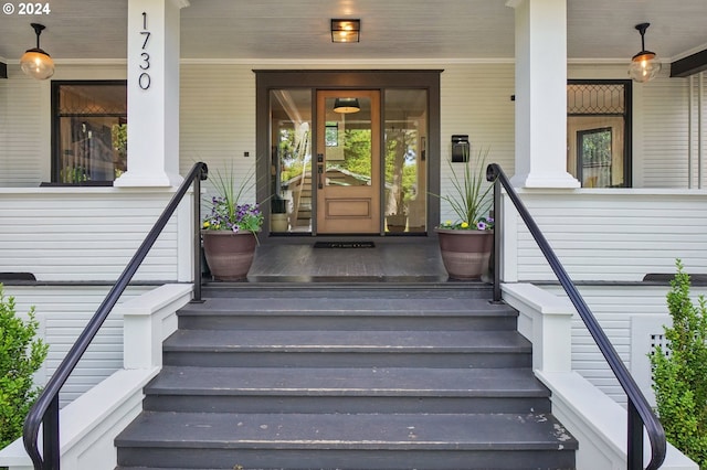 doorway to property featuring covered porch