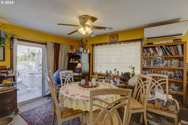 dining area with a wall mounted AC, ceiling fan, and a textured ceiling