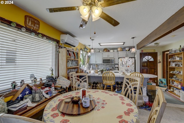 dining space featuring ceiling fan, beam ceiling, a wall mounted air conditioner, and a textured ceiling