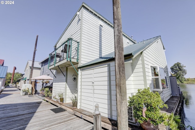 back of house with a deck with water view