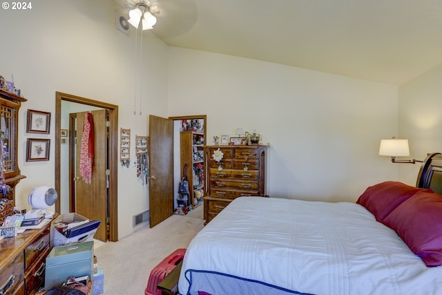 bedroom featuring lofted ceiling, ceiling fan, and light carpet