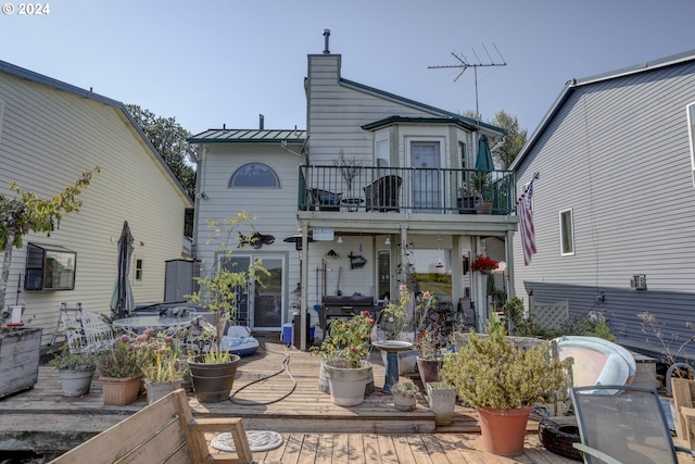 back of house with a balcony and a patio area