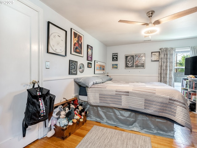 bedroom with a ceiling fan and wood finished floors