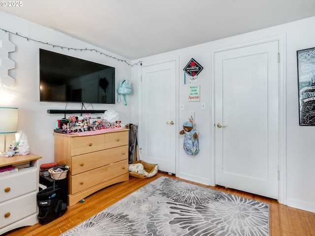bedroom with light wood finished floors