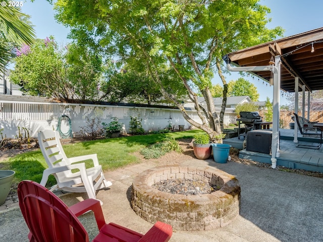 view of patio / terrace featuring a fenced backyard, a fire pit, and grilling area