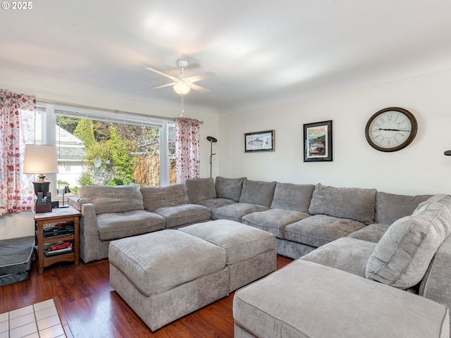 living area featuring ceiling fan and dark wood finished floors