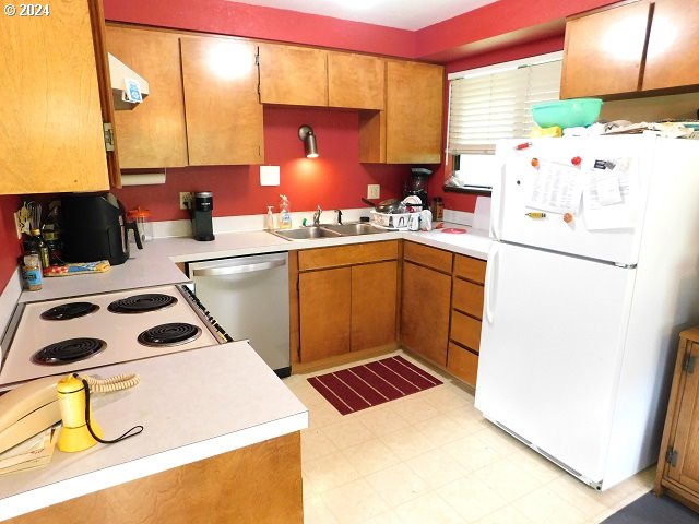 kitchen featuring sink and white appliances