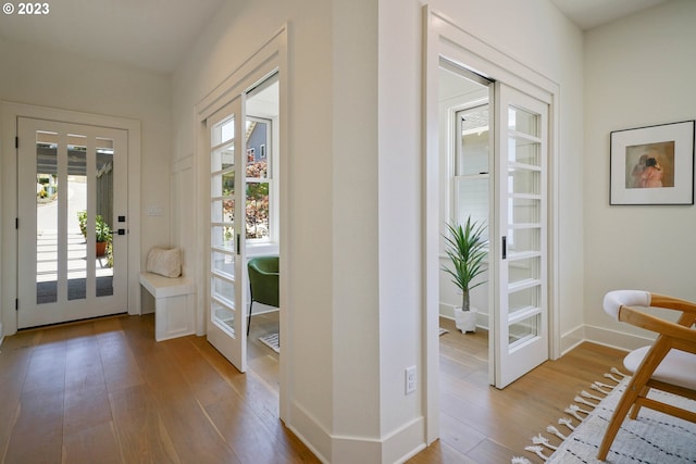 doorway to outside featuring french doors, hardwood / wood-style flooring, and a wealth of natural light