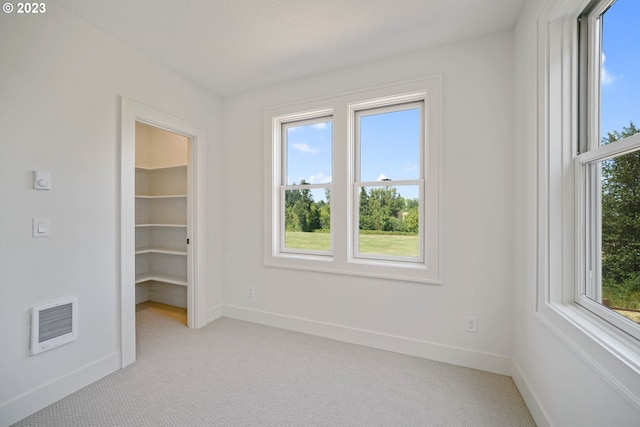 carpeted empty room with heating unit