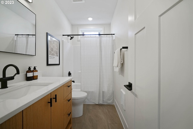 full bathroom with vanity, toilet, and shower / bath combo