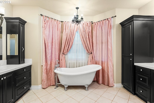 bathroom with vanity, a tub, a notable chandelier, and tile patterned flooring