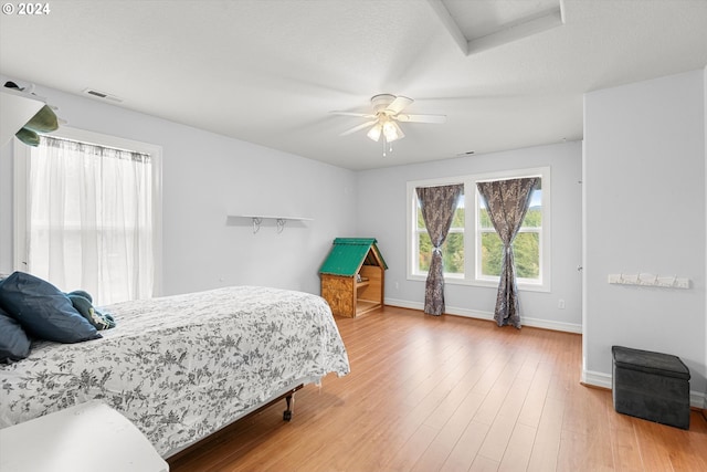 bedroom with ceiling fan and hardwood / wood-style floors