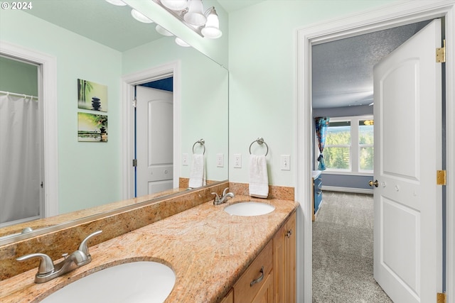 bathroom with vanity and a textured ceiling