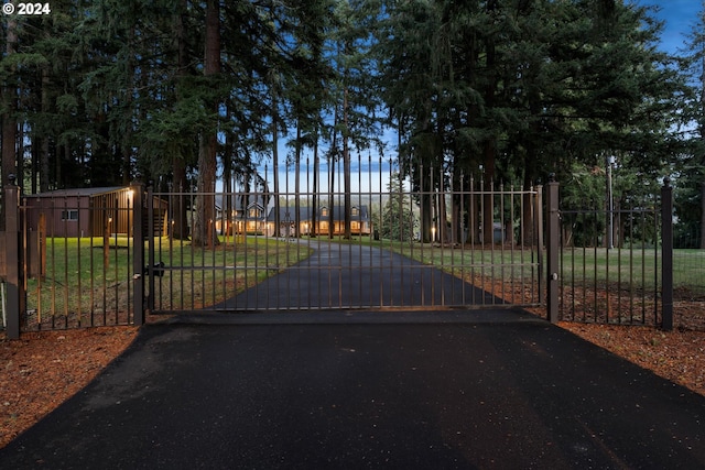 view of gate featuring a yard