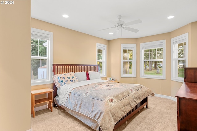 bedroom with light colored carpet and ceiling fan