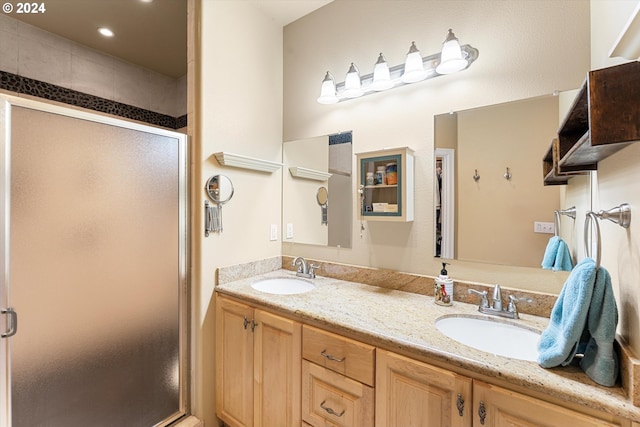 bathroom with vanity and a shower with shower door