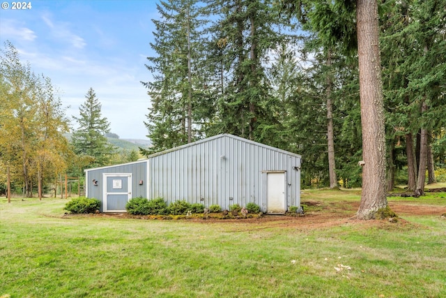 view of outbuilding featuring a yard