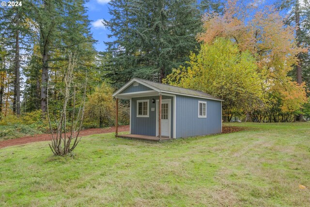 view of outdoor structure featuring a lawn