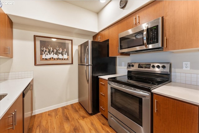 kitchen with stainless steel appliances and light wood-type flooring