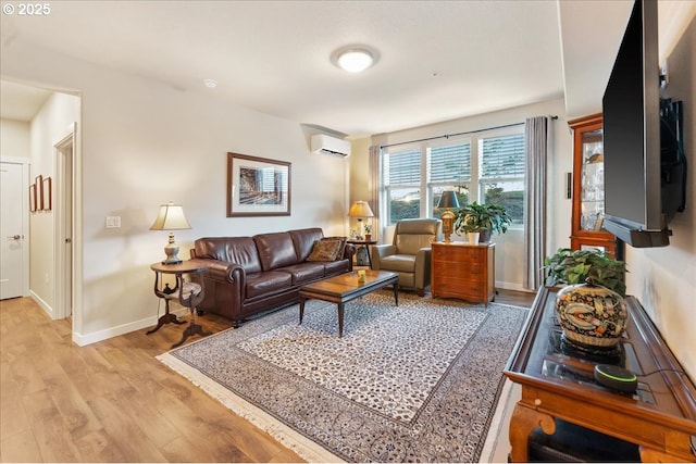 living room with a wall unit AC and light wood-type flooring