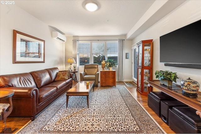 living room featuring a wall unit AC and hardwood / wood-style flooring