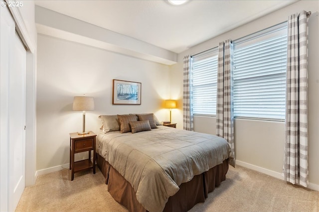 carpeted bedroom featuring a closet and multiple windows