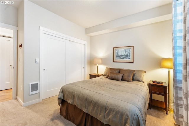 carpeted bedroom featuring a closet and heating unit