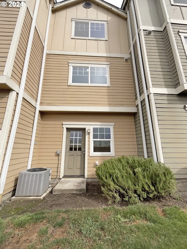 back of house featuring central AC unit